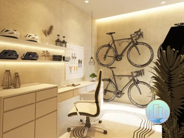 A modern home office or storage room featuring two bicycles mounted vertically on the wall, a desk with a rolling chair, and shelves displaying cycling helmets and decor.